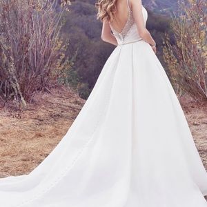 New, bought off rack. Never altered or worn for wedding. This dress is Ivory